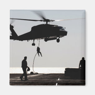 Personnel fast-rope out of an SH-60F Magnet