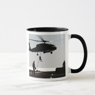Personnel fast-rope out of an SH-60F Mug