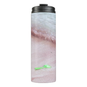 Person's foot beside green shovel on seashore thermal tumbler