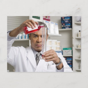 Pharmacist measuring out liquid medicine postcard
