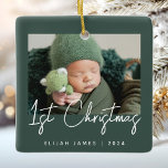 Photo Baby's First Christmas Green White Ceramic Ornament<br><div class="desc">Celebrate baby's first Christmas with this modern minimalist photo keepsake ornament. The white text reads "1st Christmas" in trendy handwriting script on a dark green background. Easily replace the sample image with your favourite photo,  and add baby's name and the year below.</div>