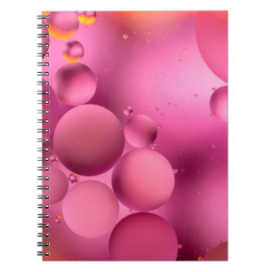 photo, bright oily drops in water with colorful ba notebook