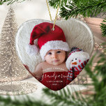 Photo Grandparents First Christmas White Script Ceramic Ornament<br><div class="desc">Help them celebrate their first grandchild with this beautiful modern keepsake ornament. The white text reads "Our first Christmas as grandparents, " with the word "grandparents" in elegant handwriting script with flourishes before and after. Easily replace the sample image with your favorite photo of the new baby, and add his...</div>