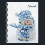 Photo of a Cute Snowman in Winter - Christmas Notebook<br><div class="desc">A personalised spiral notebook with a cute photograph of a little snowman. Standing outside in the winter with snow falling all around. This cute little guy is dressed up in blue knitted hat and scarf.</div>