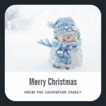 Photo of a Cute Snowman in Winter - Christmas Square Sticker<br><div class="desc">Christmas stickers with a cute photograph of a little snowman. Standing outside in the winter with snow falling all around. This cute little guy is dressed up in blue knitted hat and scarf.  Personalise with a name.</div>