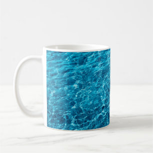 Photo of a macro bubbling blue clear sea water coffee mug