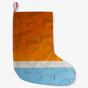 Photo of orange, white, and blue artwork small christmas stocking