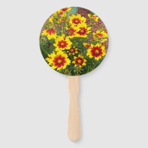 Photo of red and yellow Coreopsis Flowers on a Hand Fan