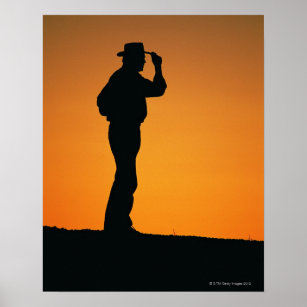 Photo, silhouette of a cowboy with his hand on poster