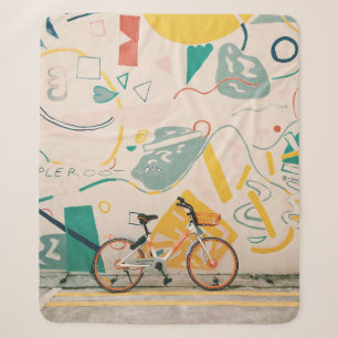 PHOTOGRAPHY OF ORANGE AND WHITE BICYCLE SHERPA BLANKET
