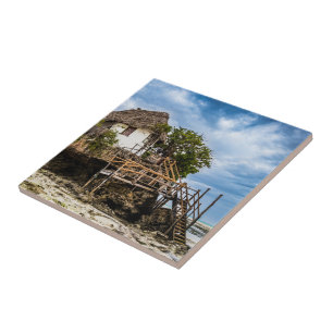 Picturesque house on a tropical coral outcrop ceramic tile