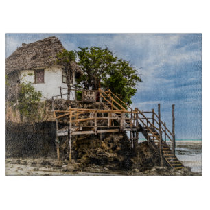Picturesque house on a tropical coral outcrop cutting board
