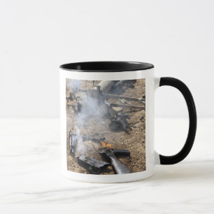 Pieces of enemy weapons lay out to cool off mug