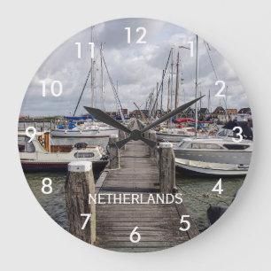 Pier with boats and yachts in Marken Netherlands Large Clock