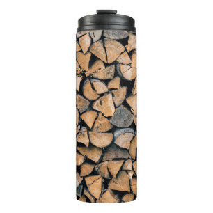 Pile of brown firewood thermal tumbler