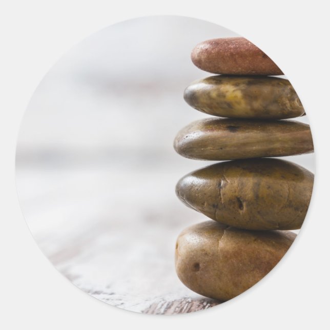 Pile of dark coloured stones on white background classic round sticker (Front)