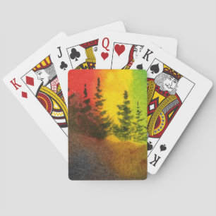 Pine trees on a hill with a colourful sunrise playing cards
