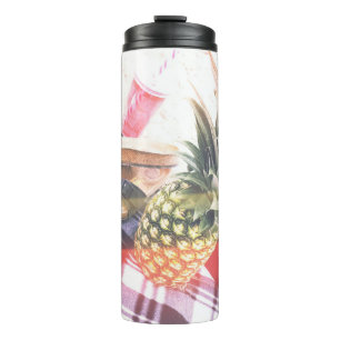 Pineapple beside phone and speaker thermal tumbler