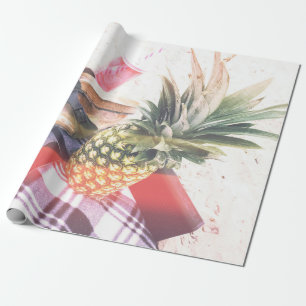 Pineapple beside phone and speaker wrapping paper
