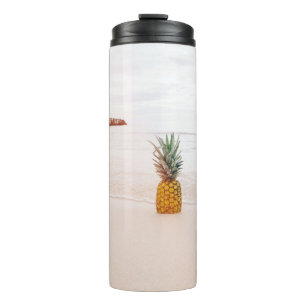 Pineapple on sand near beach thermal tumbler