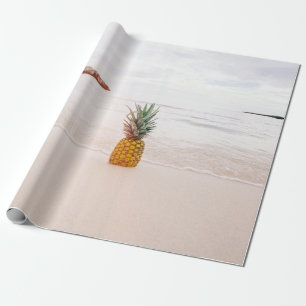 Pineapple on sand near beach wrapping paper
