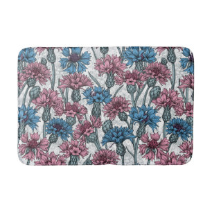 Pink and blue cornflowers, wild flowers on white bath mat
