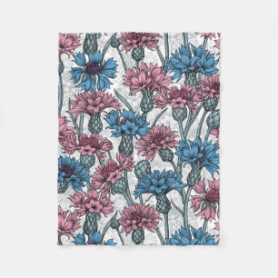Pink and blue cornflowers, wild flowers on white fleece blanket