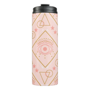 Pink and gold eyes and geometric elements in a sea thermal tumbler
