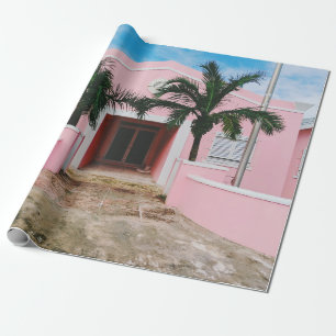 Pink and white concrete house near green trees und wrapping paper