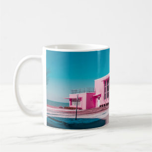Pink concrete building under clear blue sky coffee mug