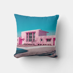 Pink concrete building under clear blue sky cushion
