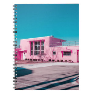Pink concrete building under clear blue sky notebook
