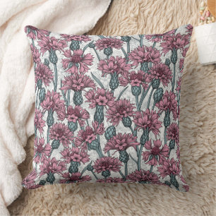 Pink cornflowers, wild flowers on white cushion