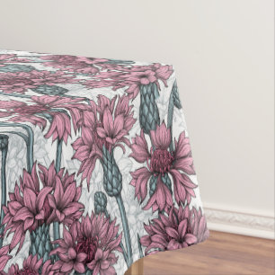 Pink cornflowers, wild flowers on white tablecloth
