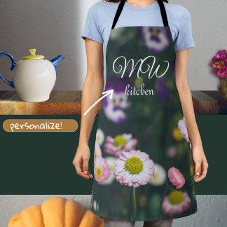 Pink daisies and pansies in the green garden apron