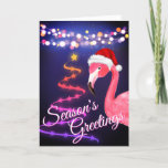 Pink Flamingo Festive Tropical Beach Christmas Holiday Card<br><div class="desc">This Season's Greetings tropical beach Christmas greeting card features a pink flamingo wearing a red and white Santa hat.  There are festive holiday string lights and a Ribbon and Stars Christmas tree.  Inside Greeting ~ "Warmest Wishes From Our Holiday Paradise To Yours".   ^</div>