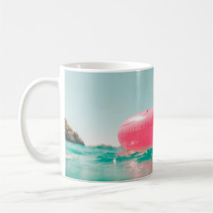 Pink flamingo swim ring on body of water in summer coffee mug