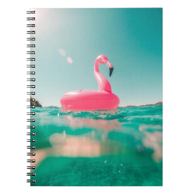 Pink flamingo swim ring on body of water in summer notebook (Front)