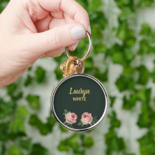 Pink flower and leaves on dark green key ring