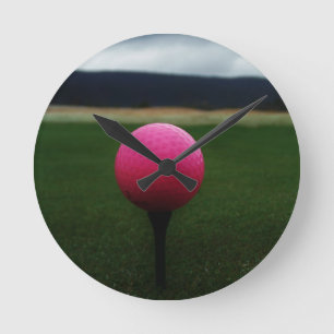 Pink Golf Ball on a mountain golf course Round Clock