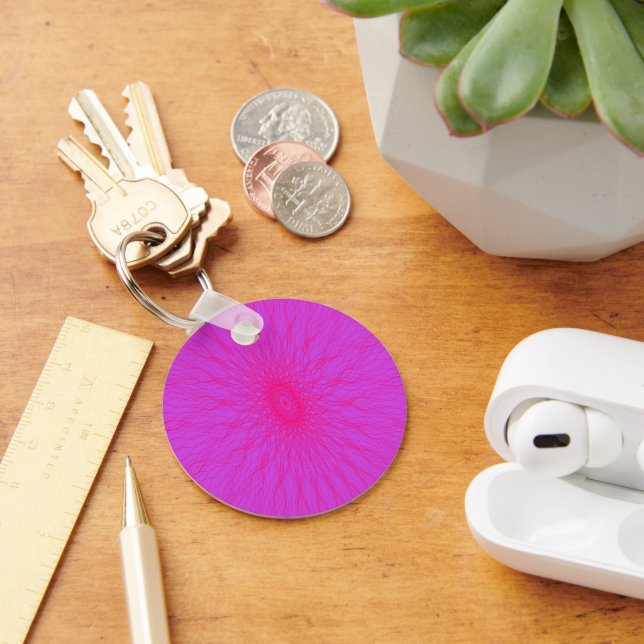 Pink mandala rays on purple keychain (Desk)