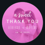 Pink Photo Wedding Thank You Classic Round Sticker<br><div class="desc">Modern round wedding thank you sticker featuring your couple photo printed under a soft pink overlay with elegant typography that reads “A Sweet Thank You.” Perfect for sealing wedding favor bags, candy boxes, or envelopes. This personalized photo sticker adds a romantic and cohesive touch to your wedding stationery suite —...</div>