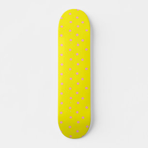 Pink polka dots on yellow skateboard