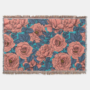 Pink roses with blue leaves on blue throw blanket