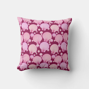 Pink sea shells on a burgundy background cushion