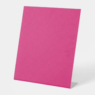 Pink textured surface with subtle swirling pattern pedestal sign
