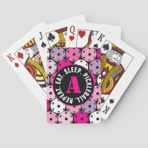 Pink, white and purple pickleballs, with initial playing cards