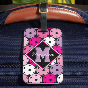 Pink, white and purple pickleballs, with name luggage tag