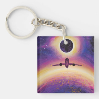 Plane in flight city and eclipse key ring