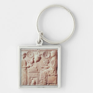 Plaque of a woman offering gifts to a seated key ring